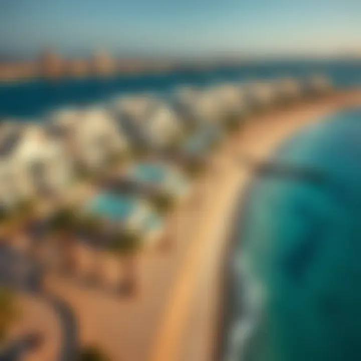 Aerial view of the luxurious properties lining the coastline of Jumeirah Beach 2 with palm trees and modern architecture