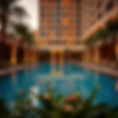 Luxurious swimming pool area at The Ritz Carlton Residences Dubai surrounded by greenery